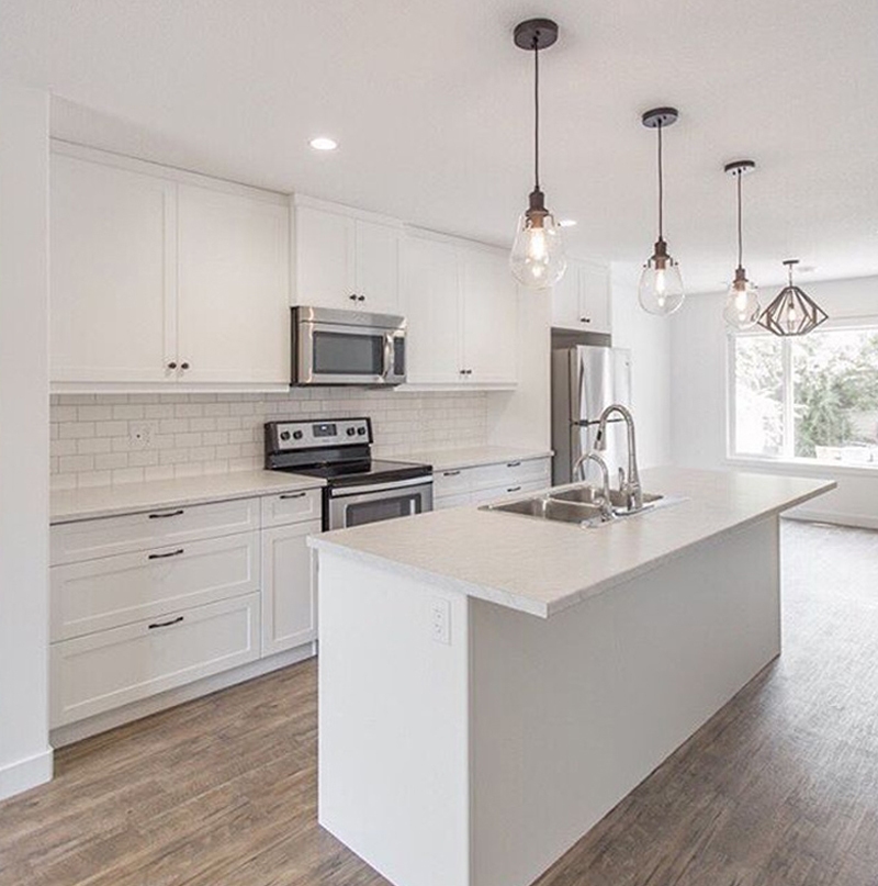 Urban Complex modern white kitchen cabinet installation with central island
