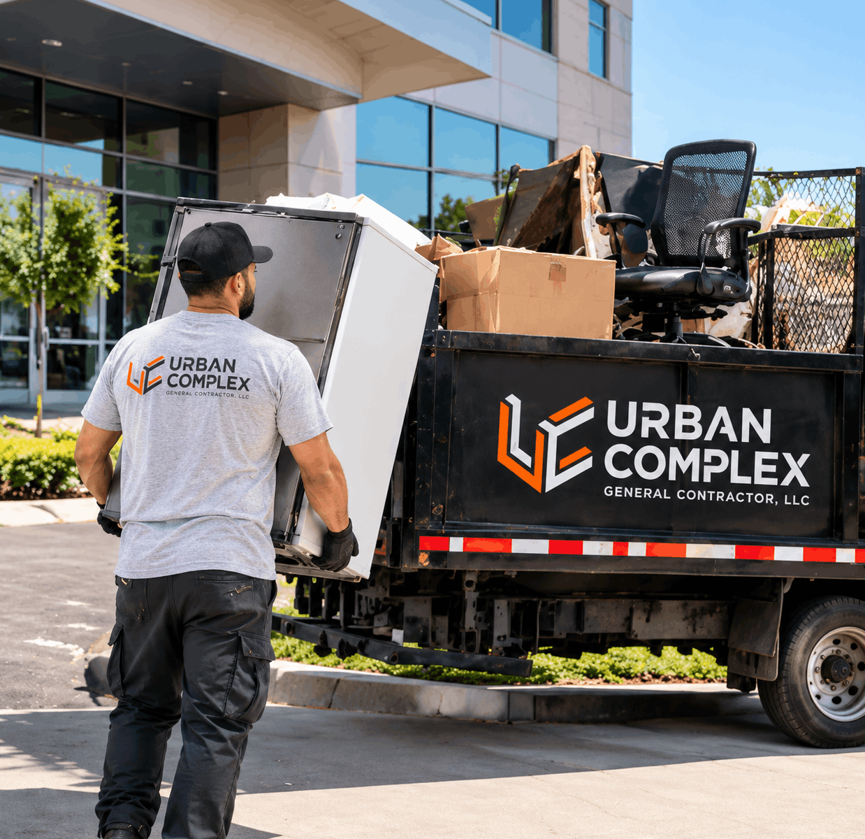 Urban Complex crew loading an appliance for trash out and haul-away service
