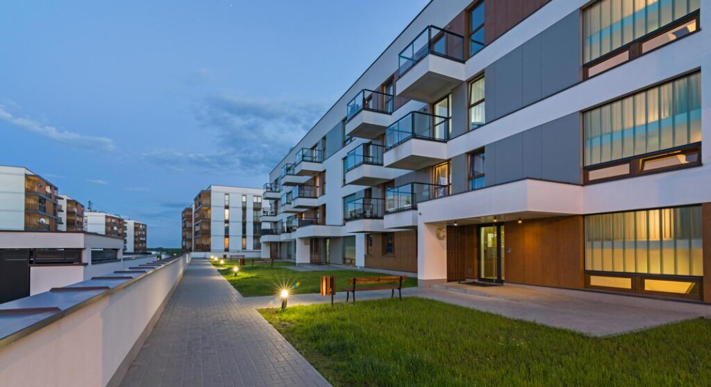 Construction workers reviewing plans in an eco-friendly apartment building