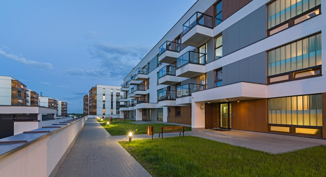 Construction workers reviewing plans in an eco-friendly apartment building